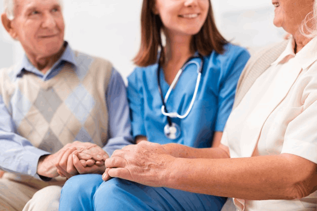 old-man-woman-sitting-yellow-sofa-with-nurse_23-2148238969@1X